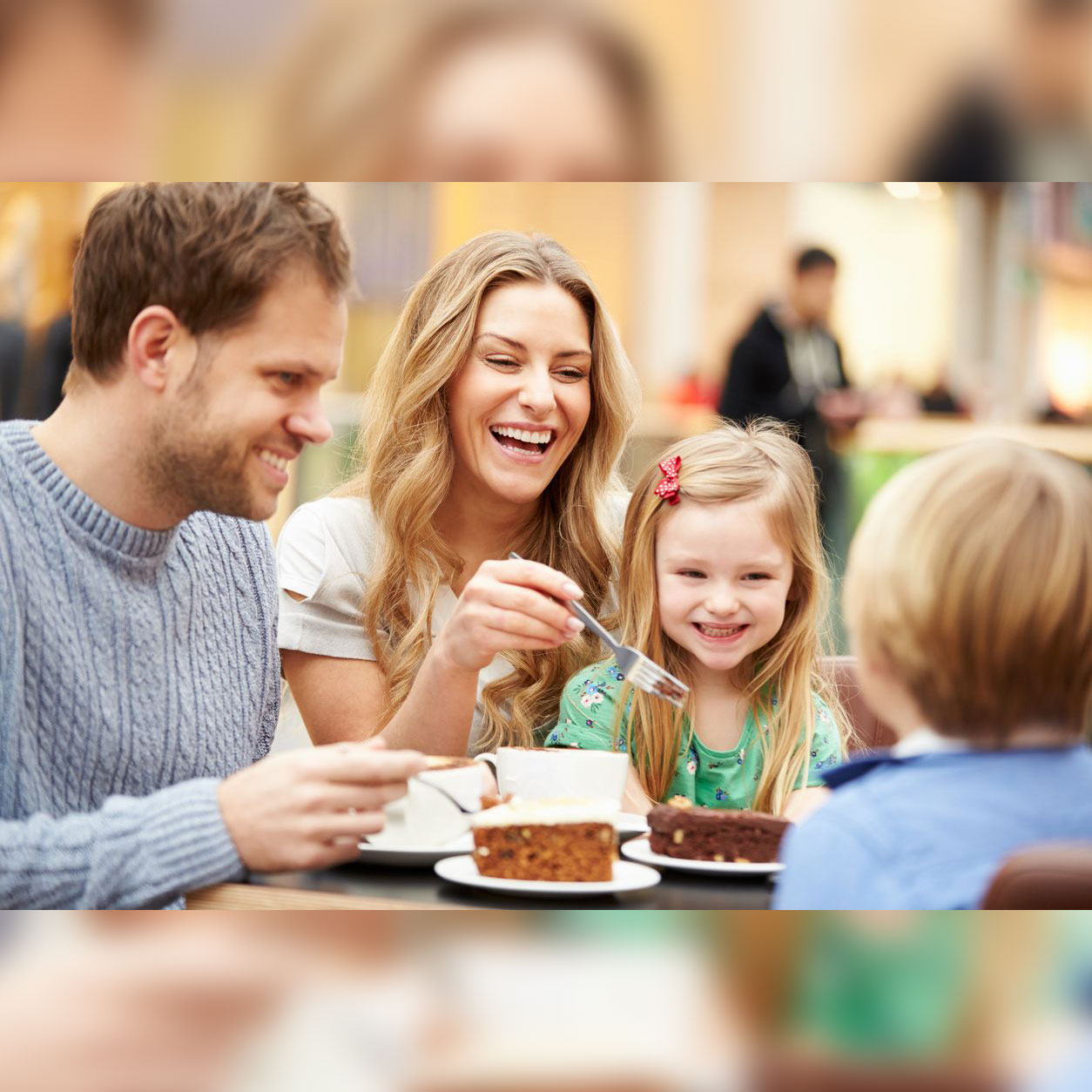 A family eating cake at the restaurant